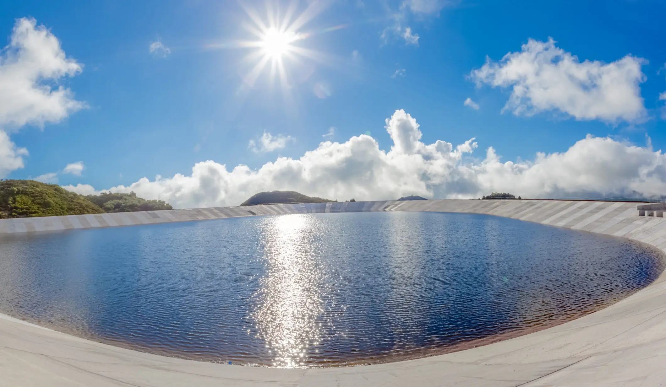 A dugout filled with water, serving as a natural reservoir or storage for irrigation, livestock, or recreational use, reflecting harmony with the environment and resource management.