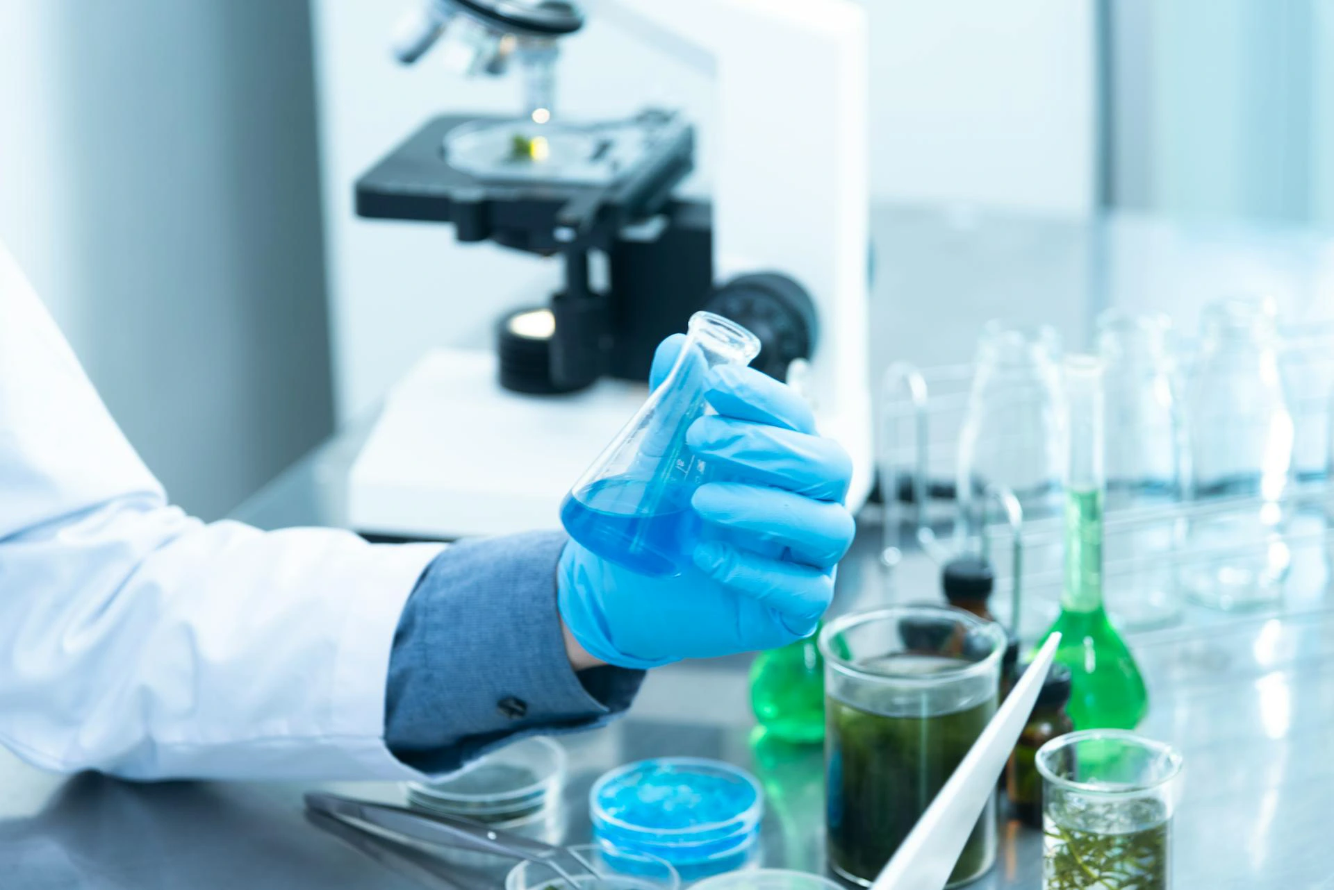 a scientist looking at a vial of water for testing