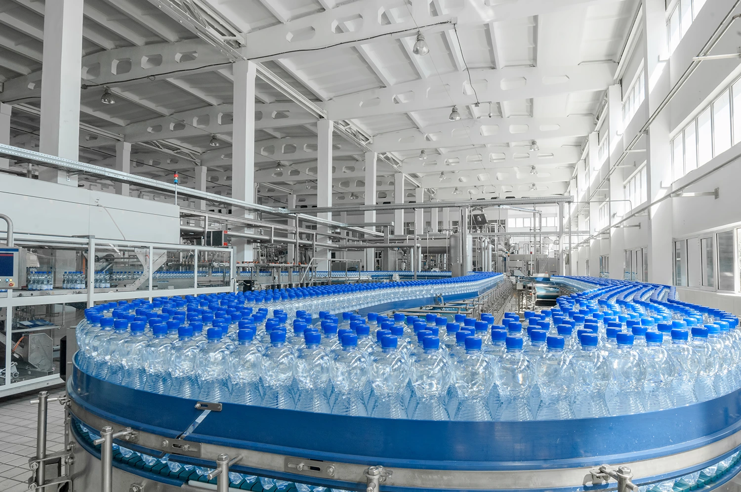 hundreds of water bottles being sent down a conveyor belt