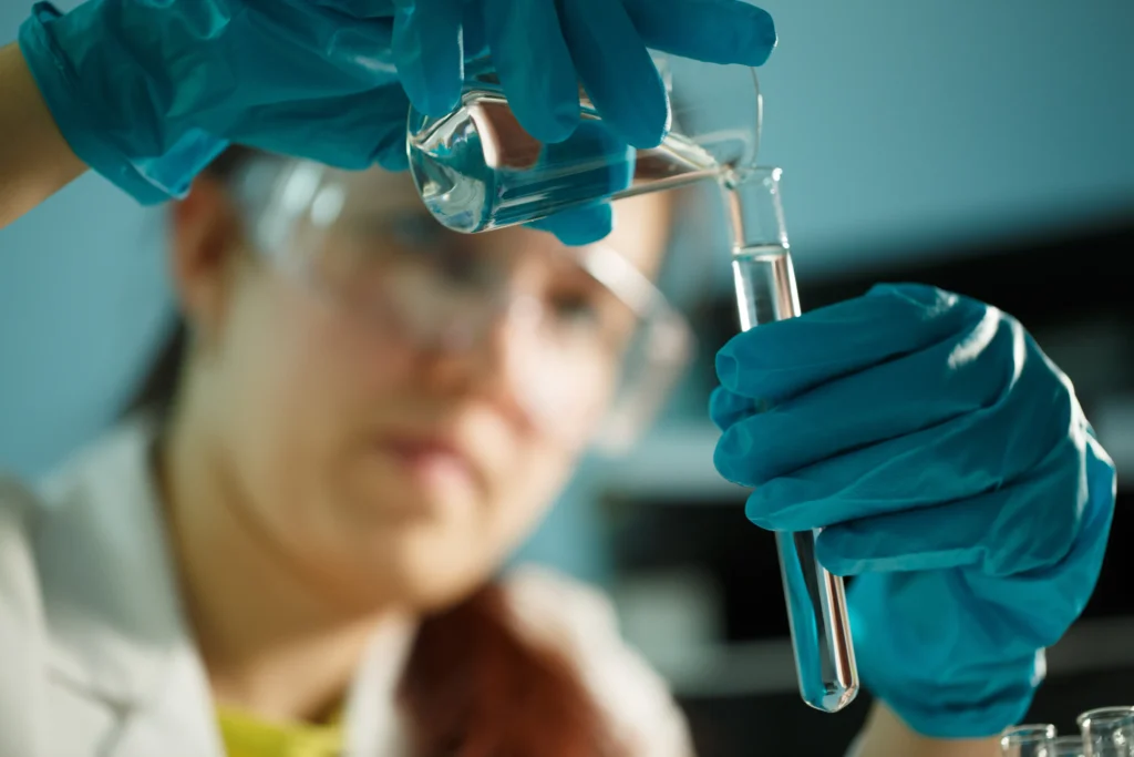 scientist mixing a few chemicals into water for treatment