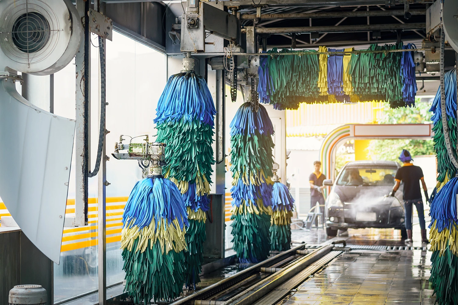 people sending a car through a car wash