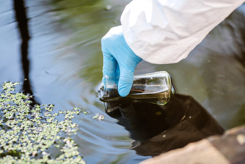 scientist filling up beaker with water for testing