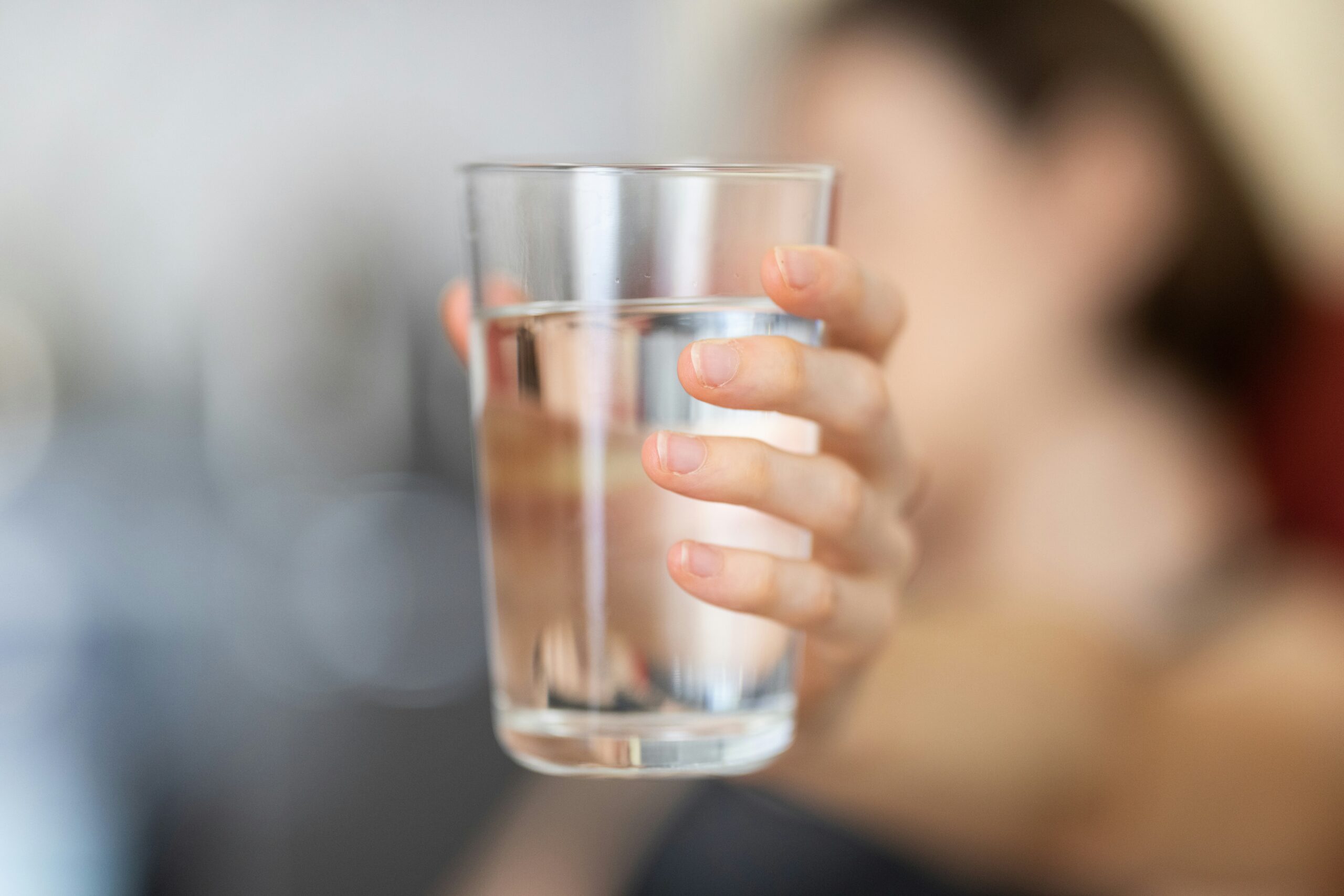 Person holding a glass of water